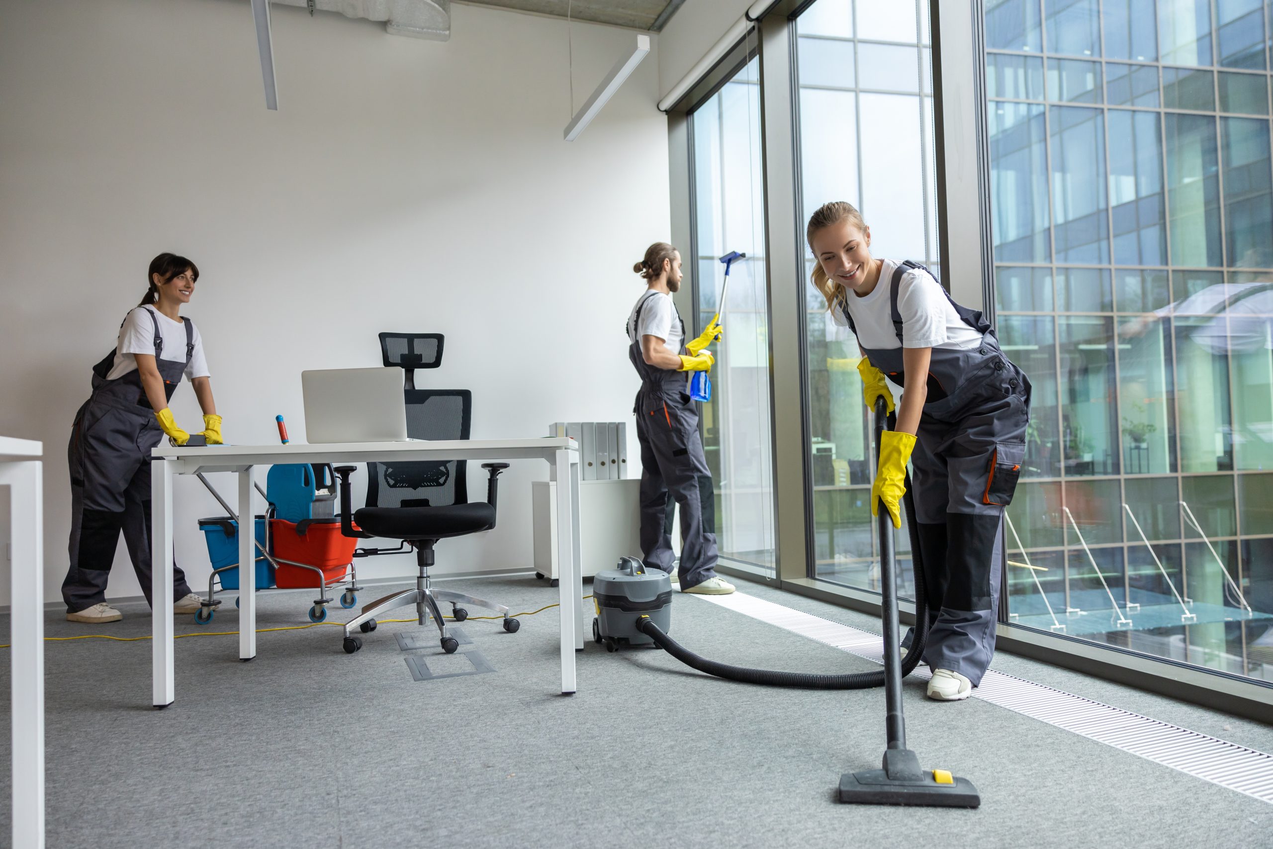 Hygiene in the office. Housekeeping team cleaning the conference room and looking busy and involved